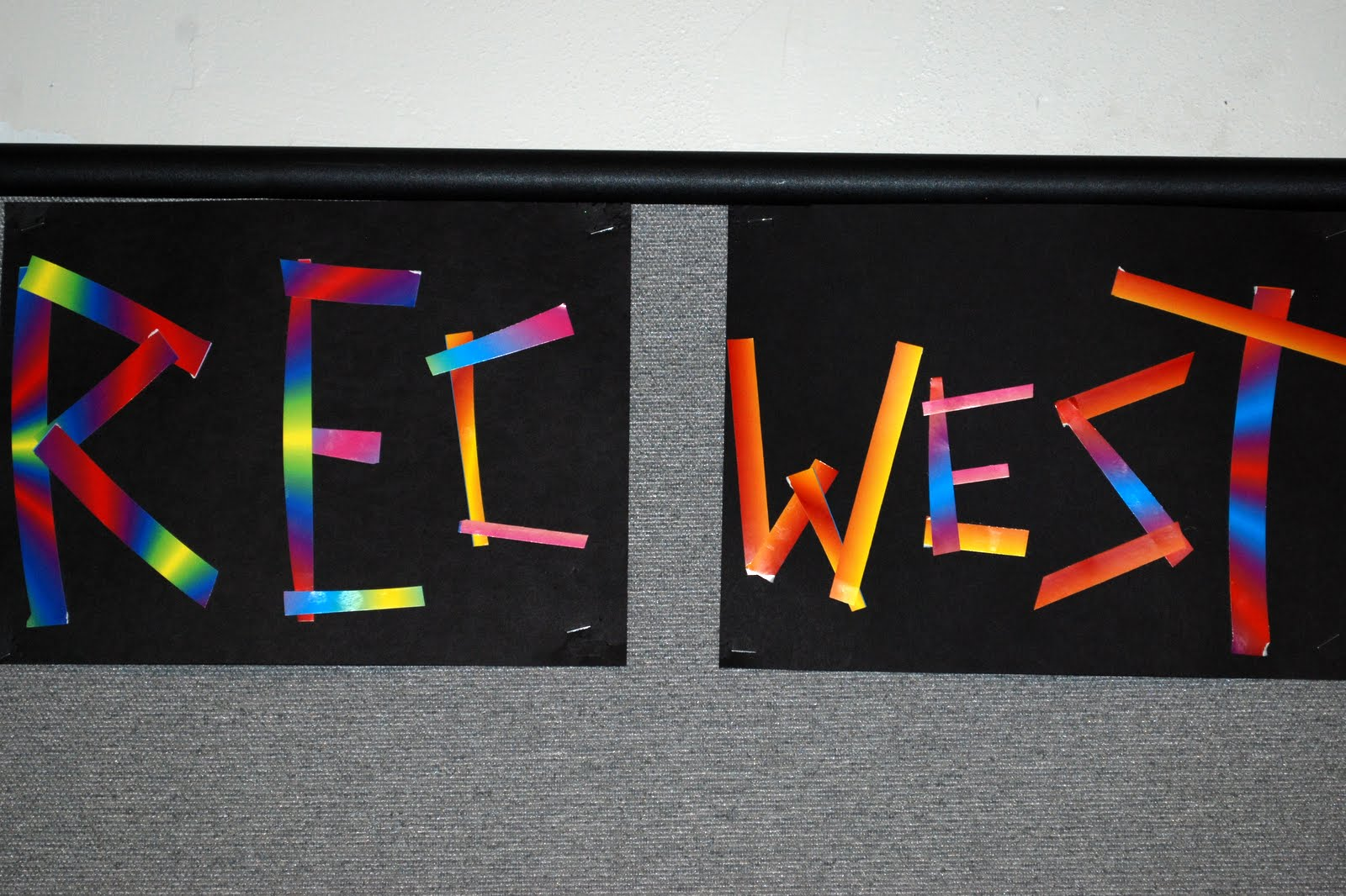 A colorful, hand-lettered REC WEST sign in the lobby