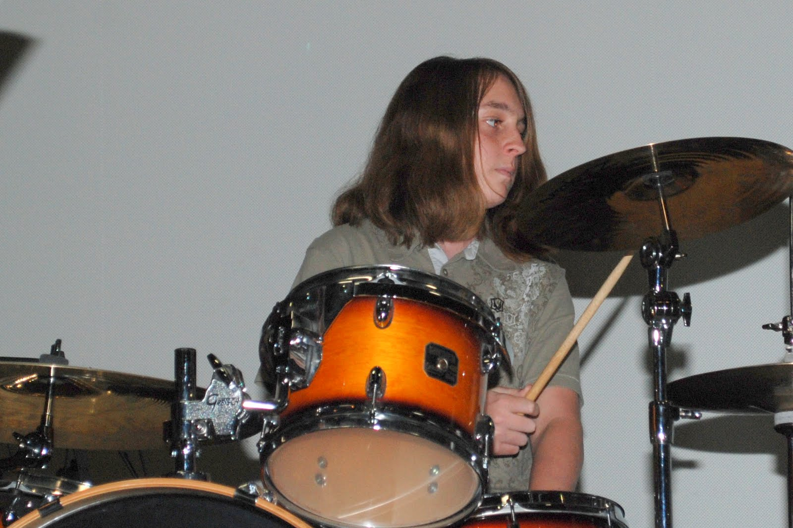 A young drummer performing