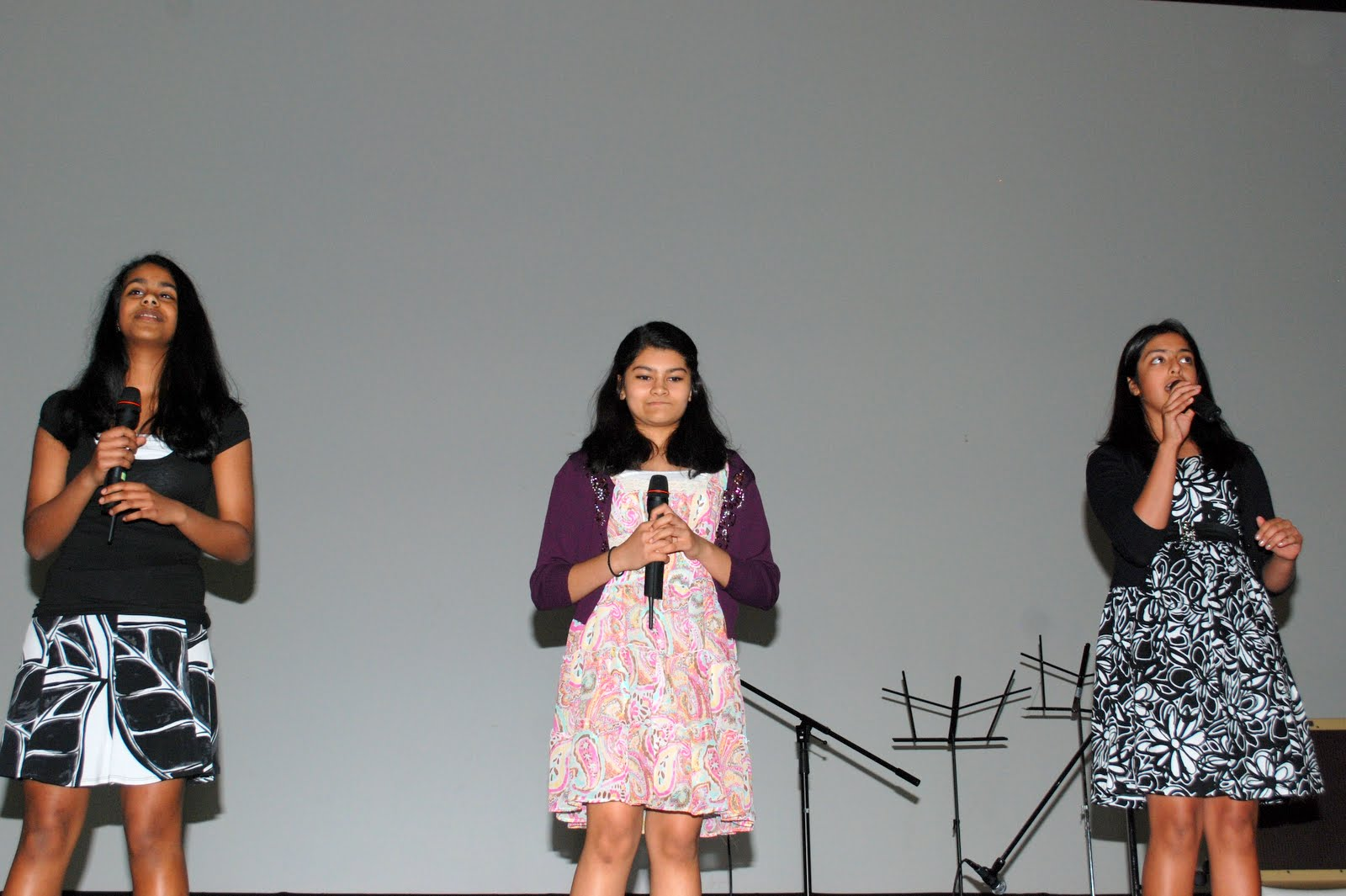 Three girls singing together
