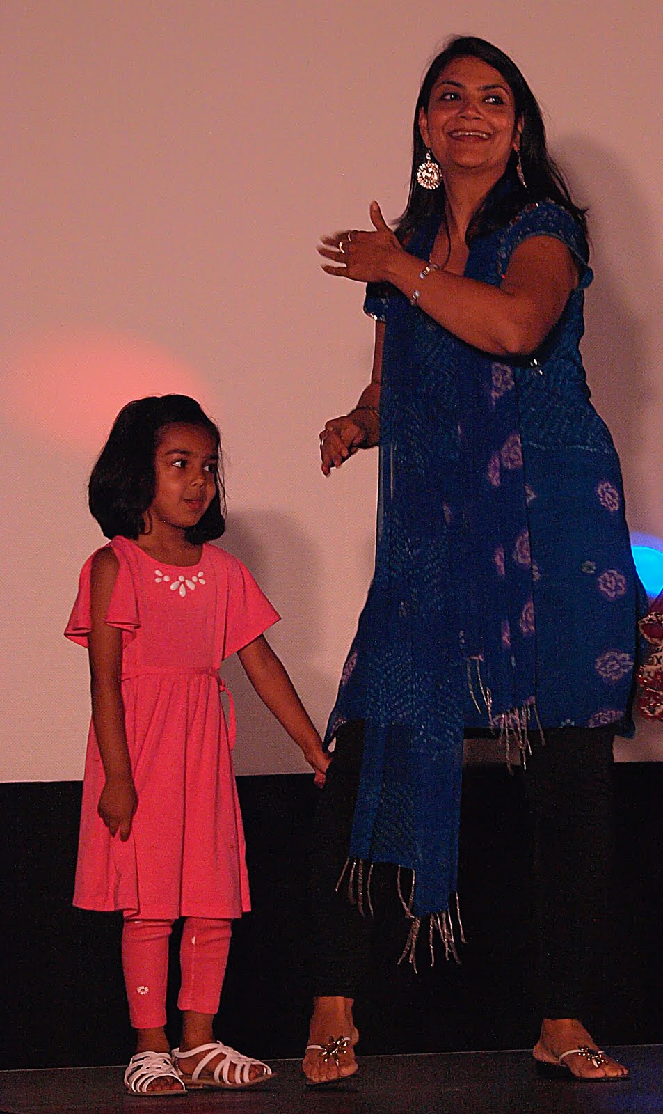A young girl dancing with a performer