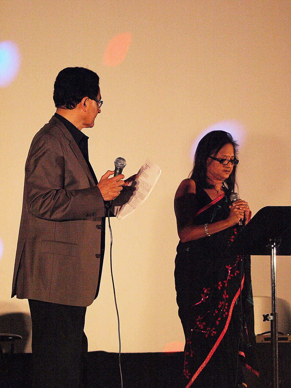 A man and woman singing a duet at a music stand