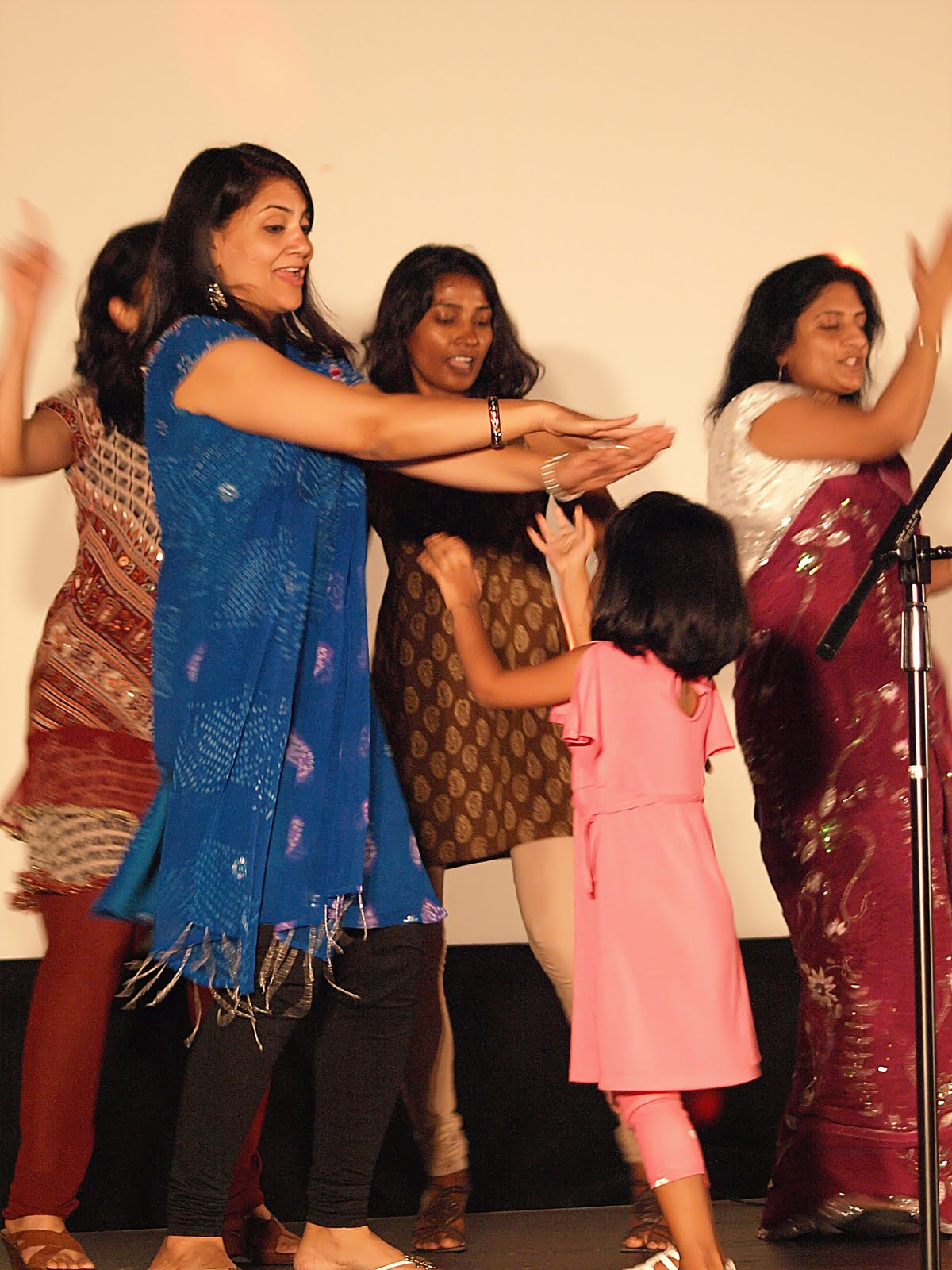A group of performers dancing together