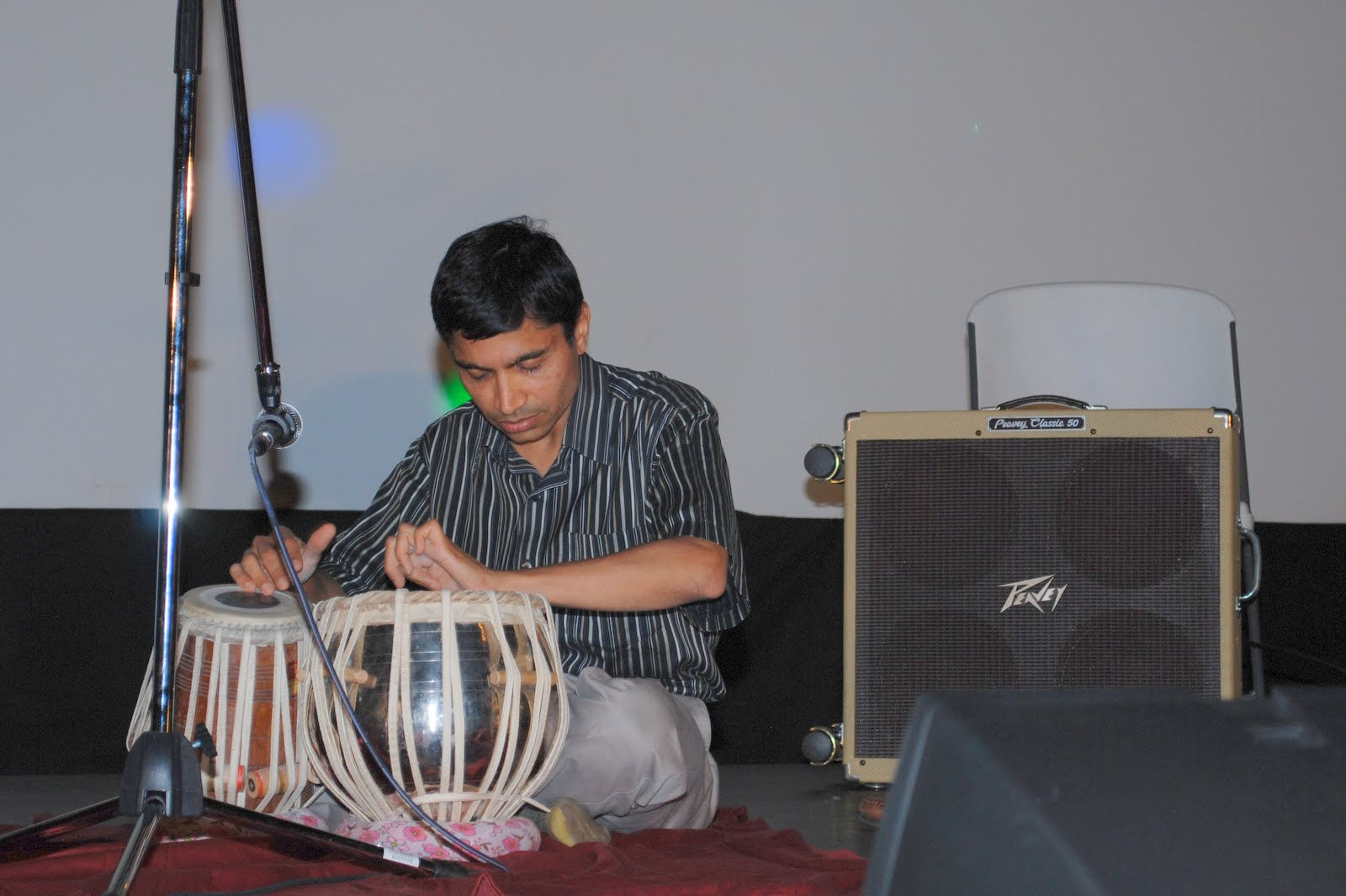 A young musician playing tabla