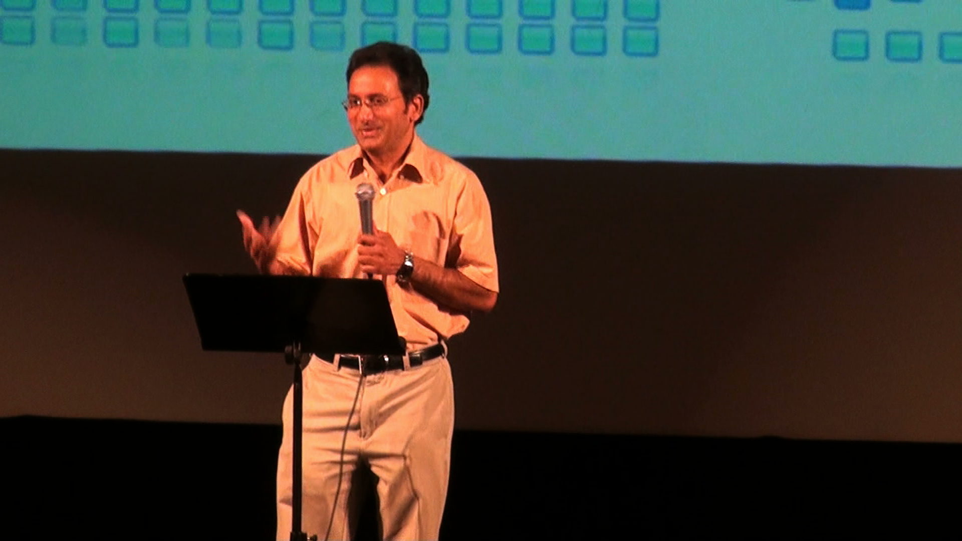 A man singing with an animated gesture