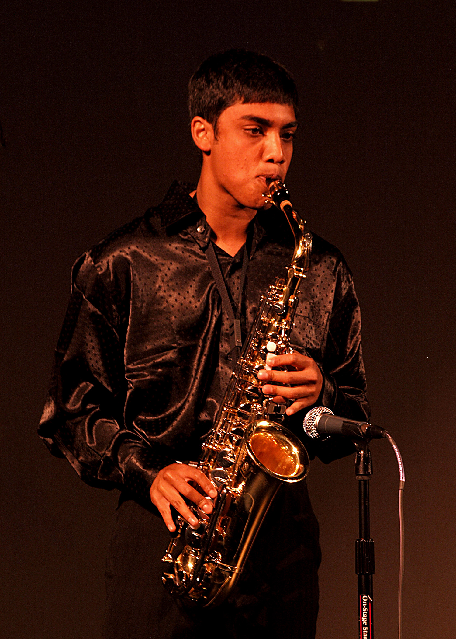 A young man playing saxophone