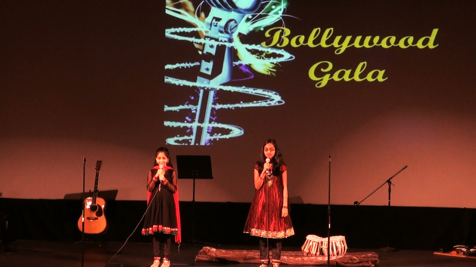 Two young girls singing together