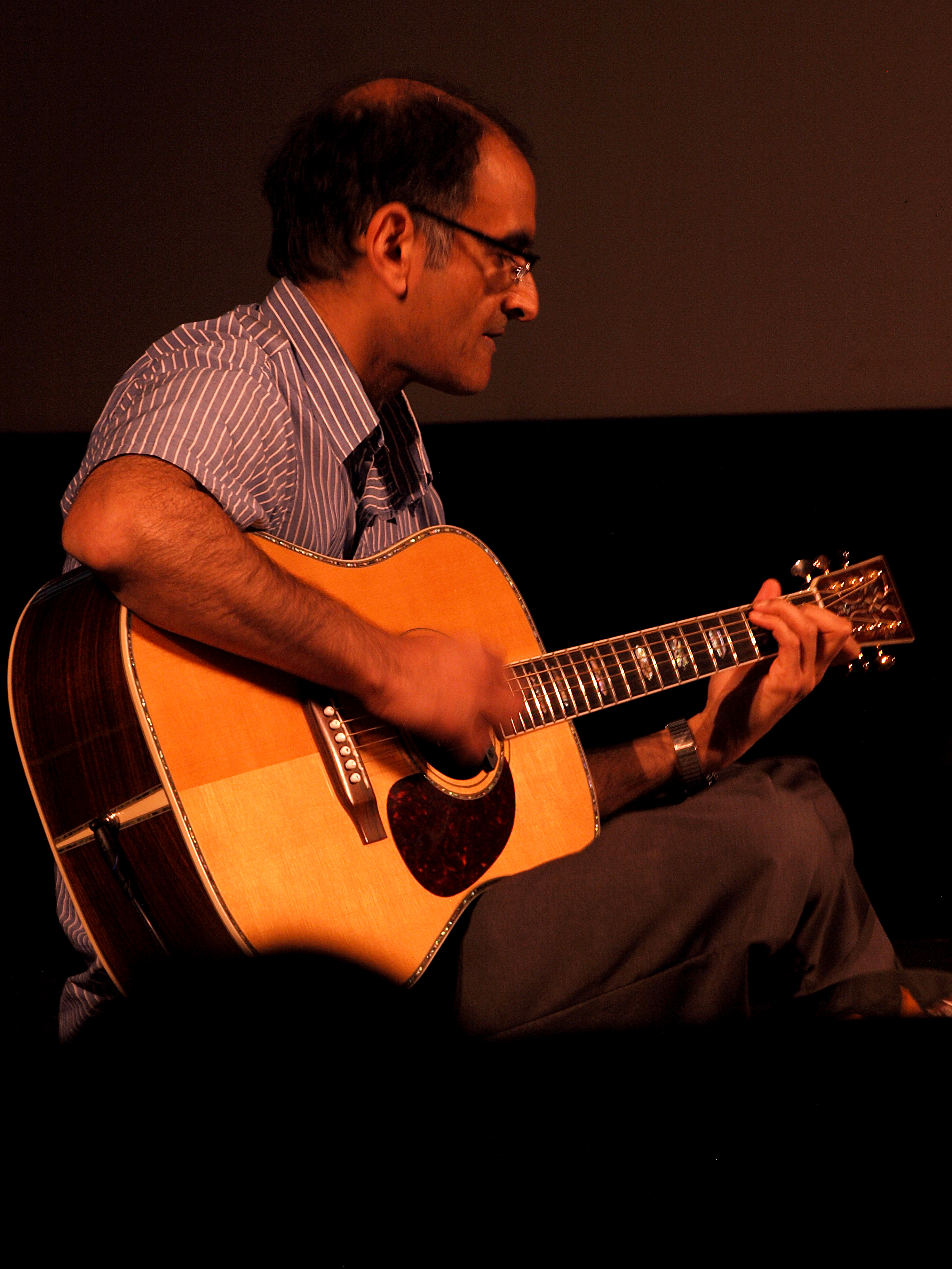 A man playing acoustic guitar