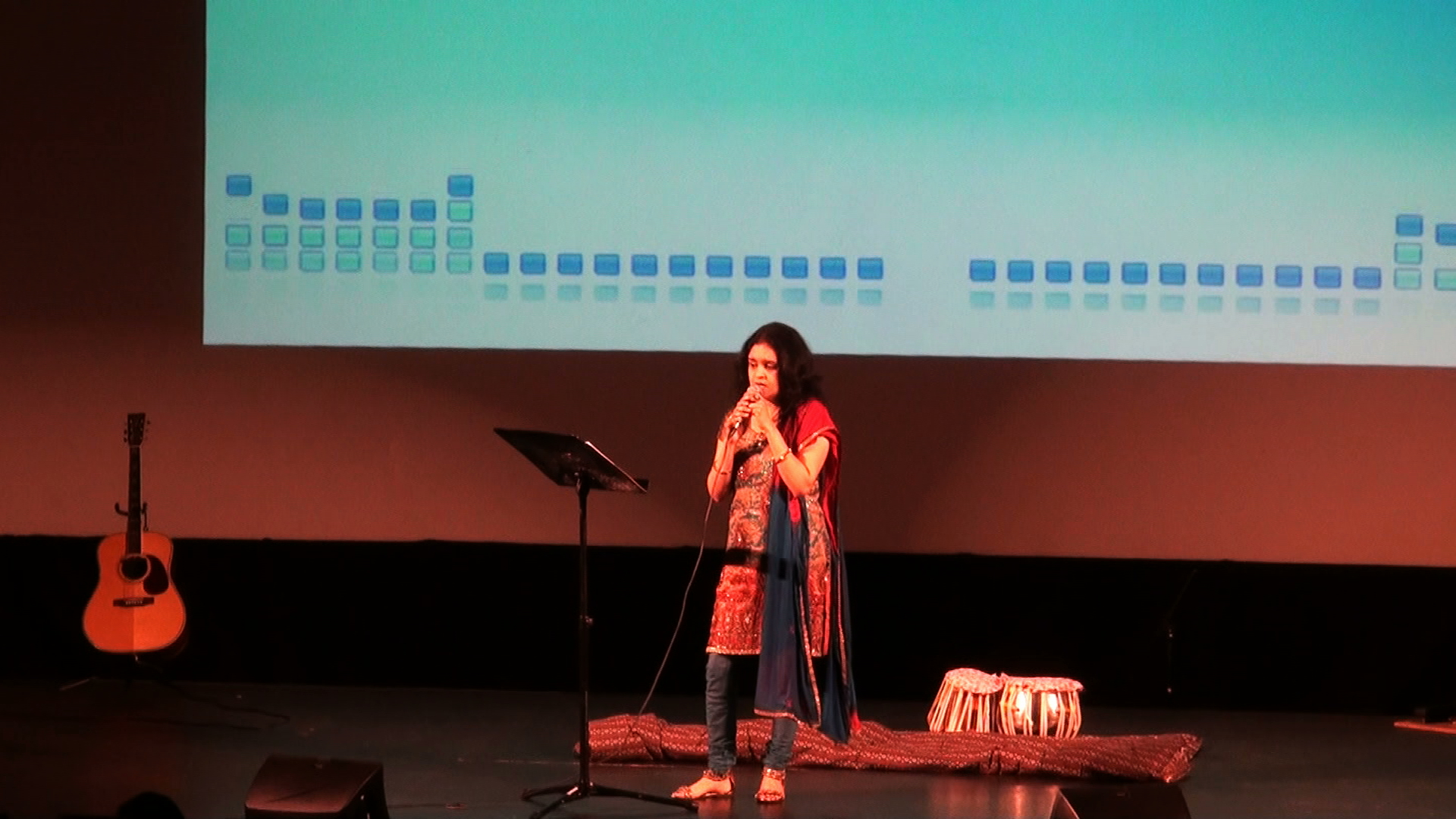 A woman and a young girl singing together