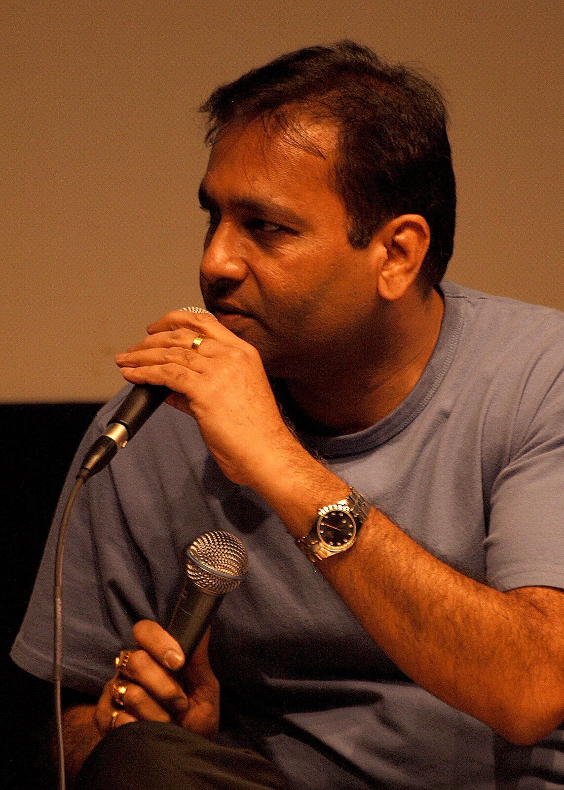 A man singing, seen in profile
