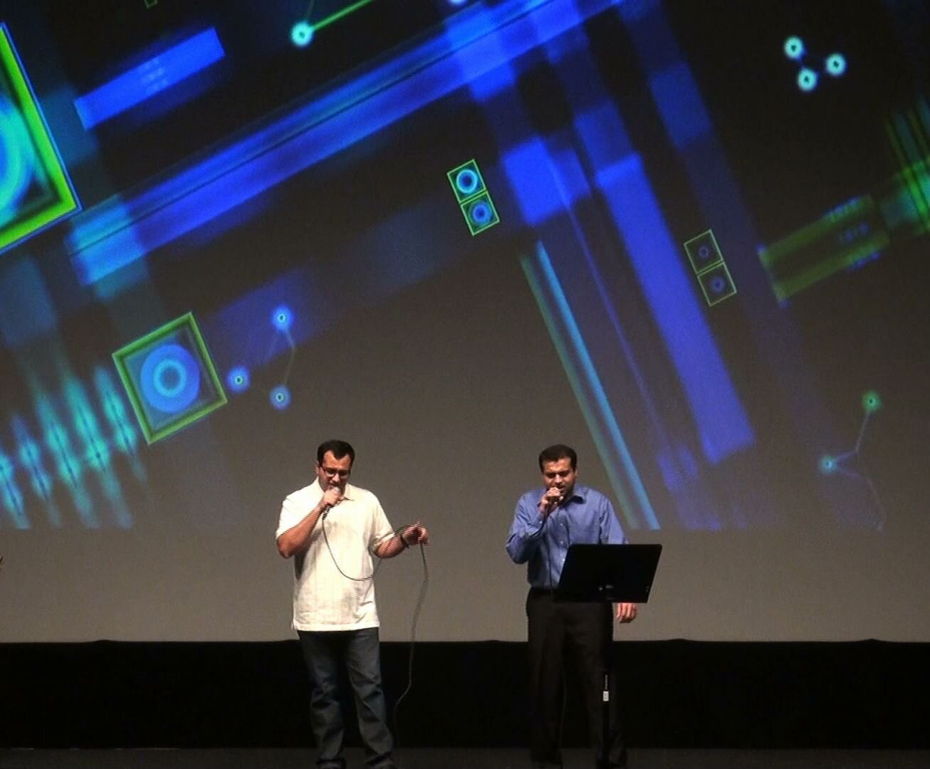 Two men singing together on stage