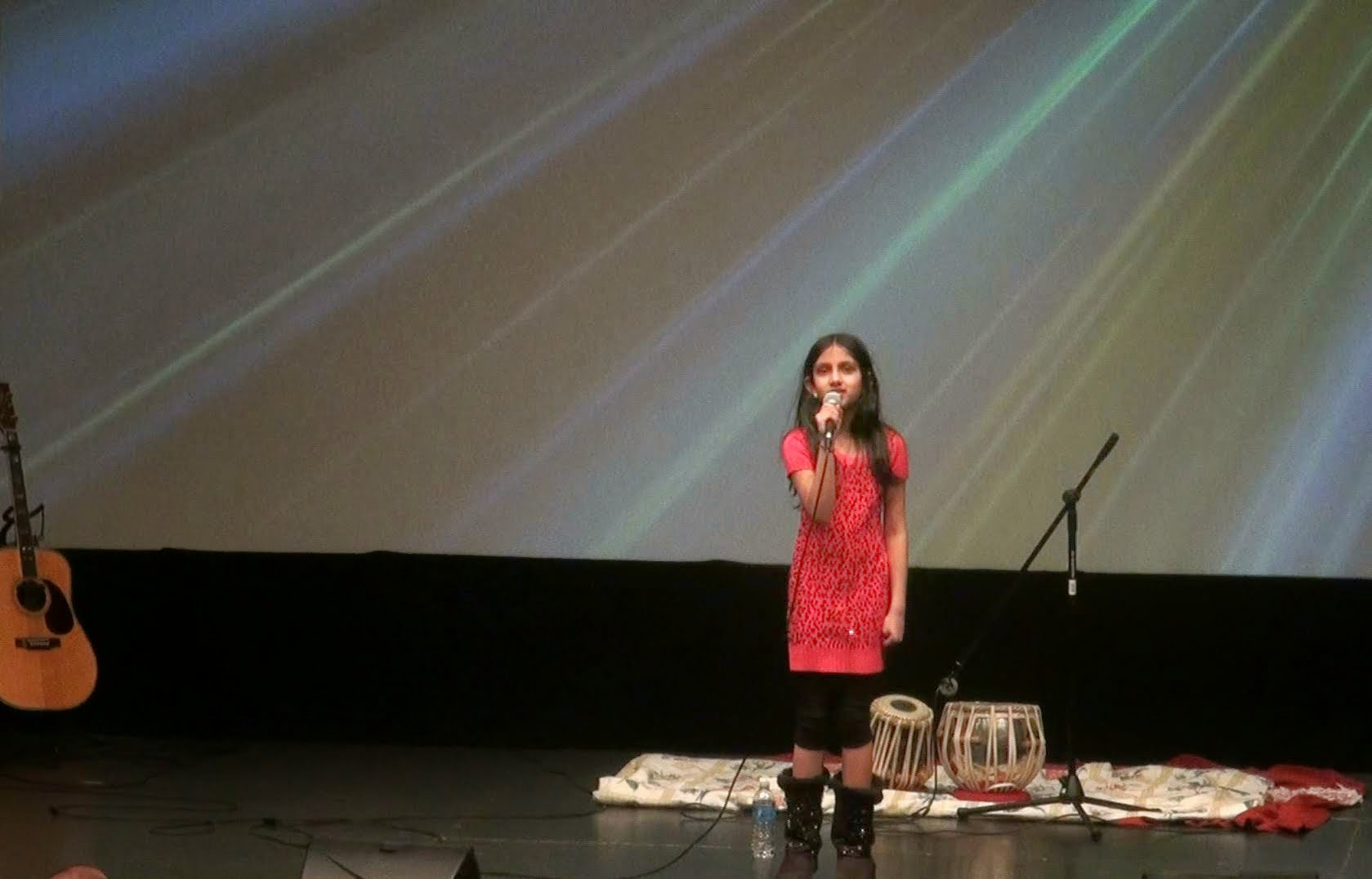 A woman in red singing
