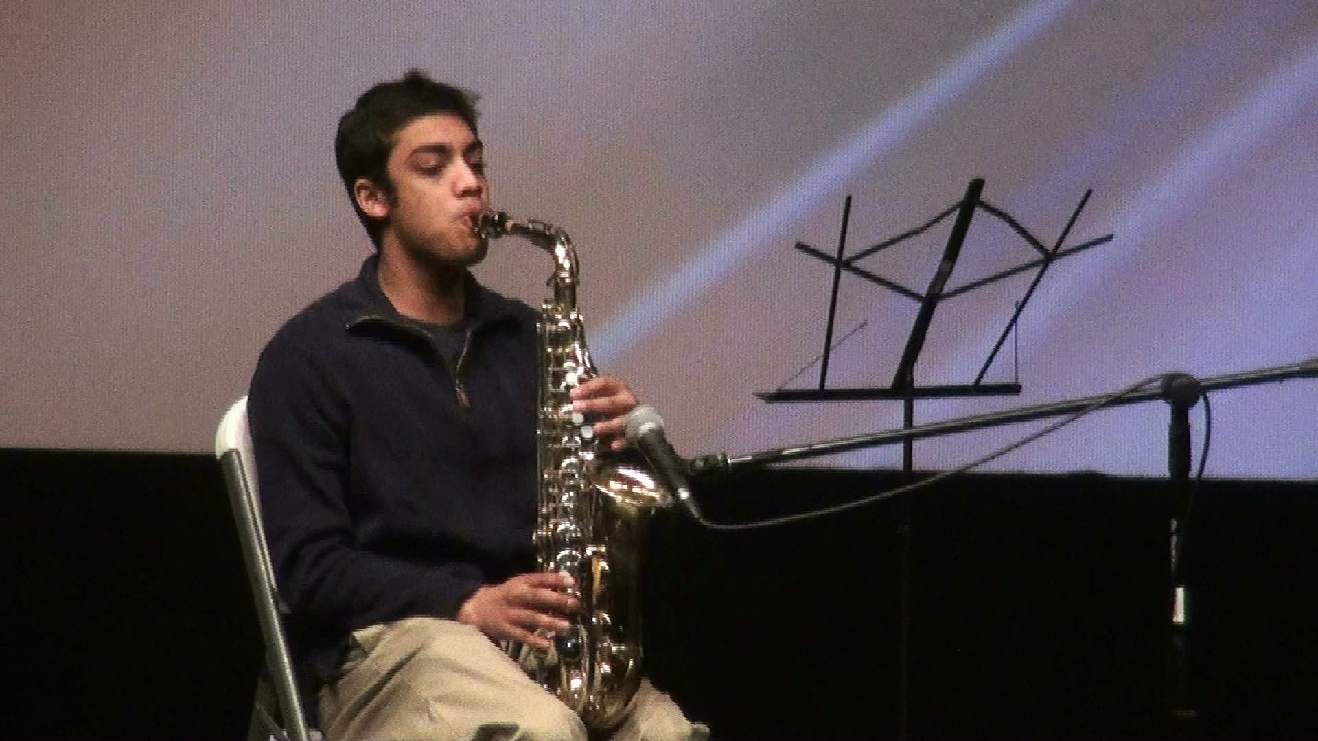 A young man playing saxophone