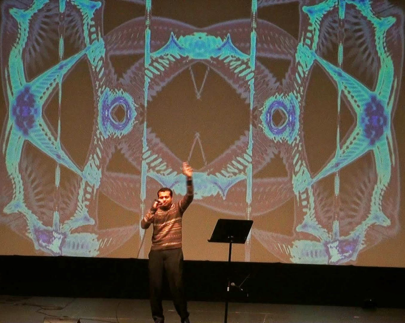 A man singing with an animated pose