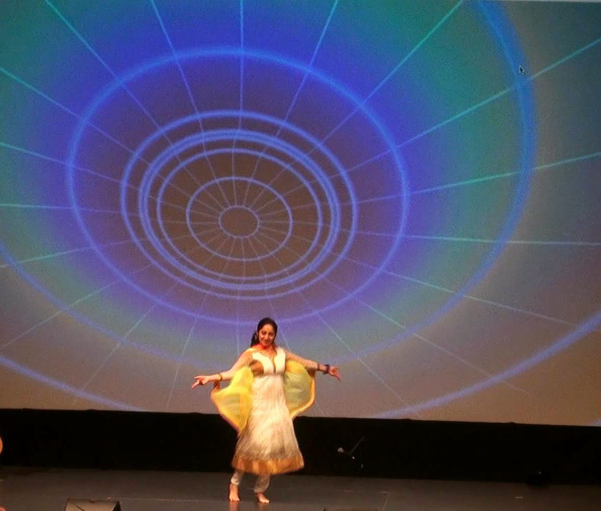 A woman dancing in a yellow outfit