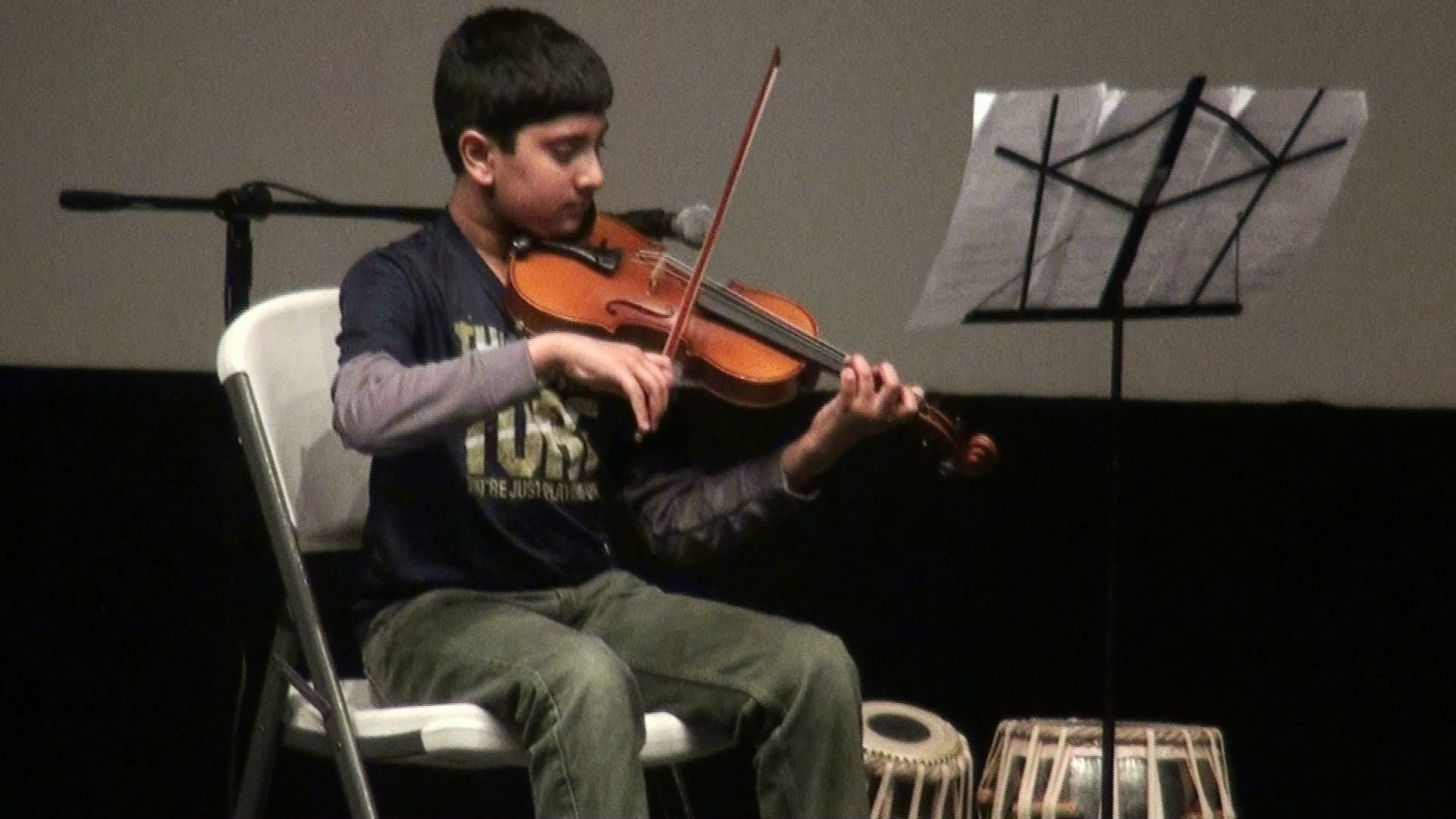 A young boy playing violin
