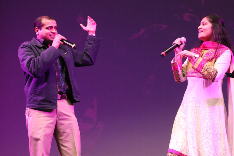 A man and a woman singing a duet together