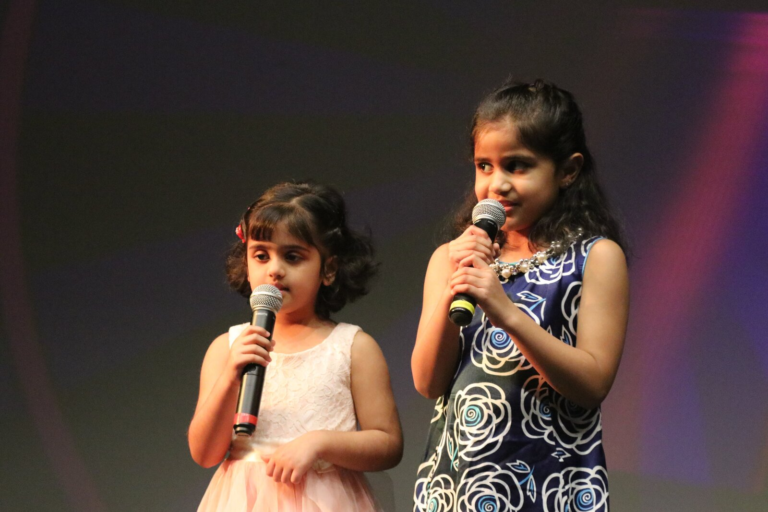 Two young girls singing together