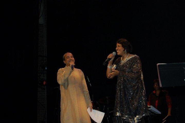 Kavita Krishnamurty and Suresh Wadkar sharing a laugh on stage.