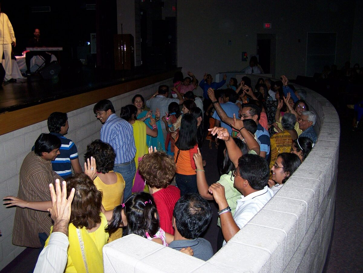 Concertgoers dancing at the rail as the show wraps up.