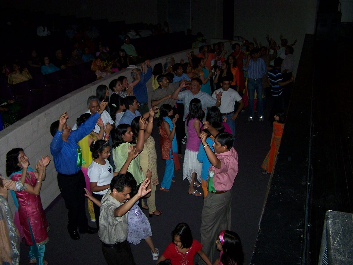 The audience up and dancing at the balcony rail.