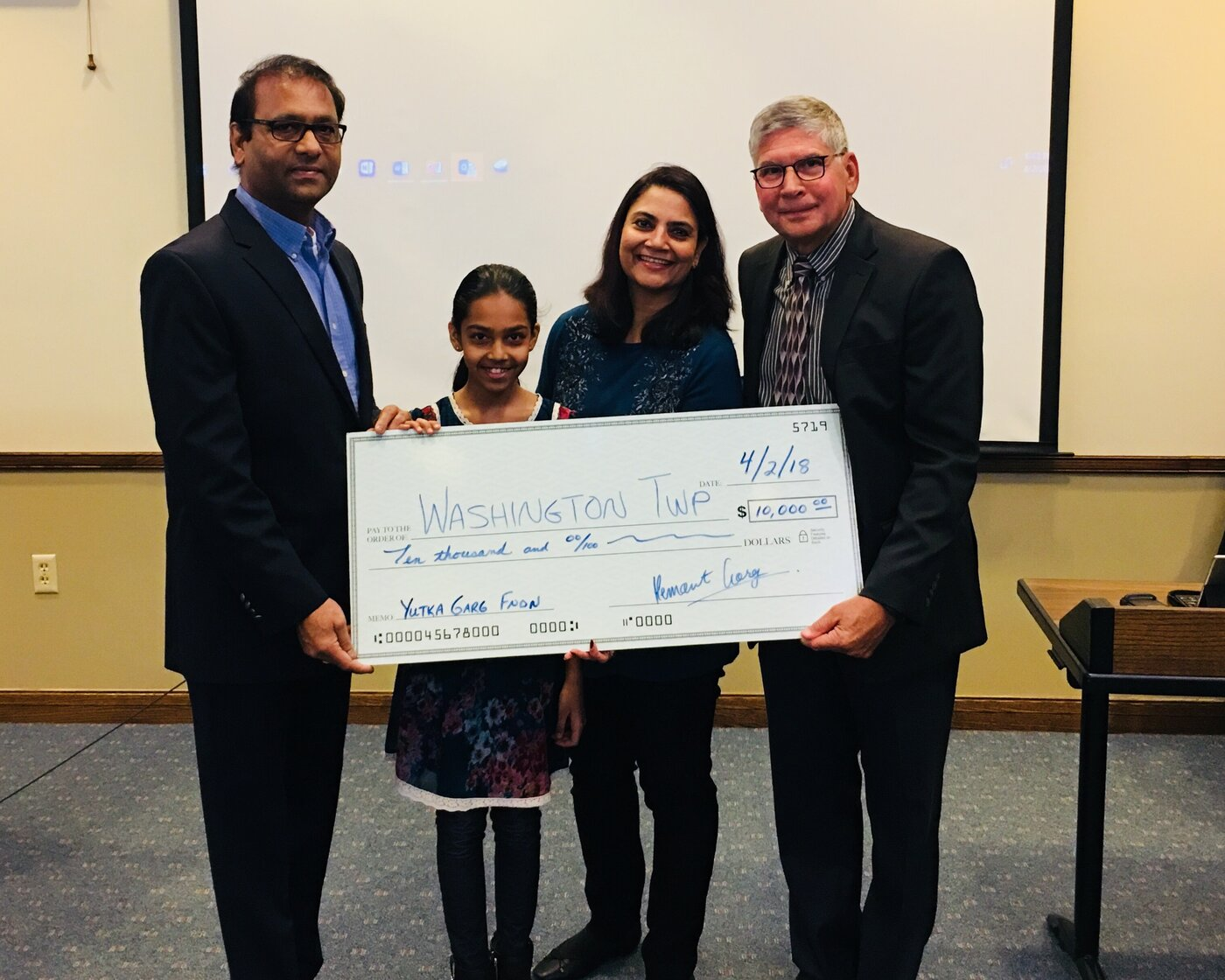Hemant, Arti, and Ishita Garg presenting the first $10,000 check to Washington Township, April 2, 2018